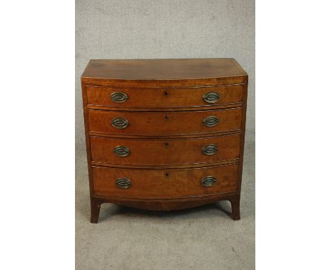 A George III mahogany bow front chest of small proportions, with four long graduated drawers, over a shaped apron with splaye