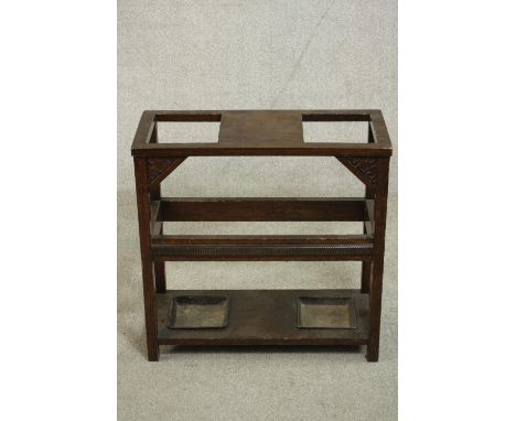 A Victorian oak umbrella stand, of rectangular form with two square openings for umbrellas and two drip trays. H.60 W.61 D.26