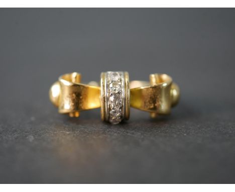 A yellow metal (tests as 14 carat) and diamond bow design ring, set with five cushion shaped old mine diamonds with a combine