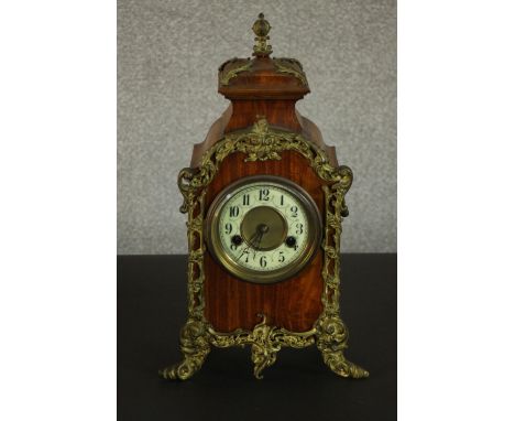 A 19th century gilt spelt ormolu and mahogany mantle clock with enamel chapter ring with black numerals. (working) H.40 W.24 