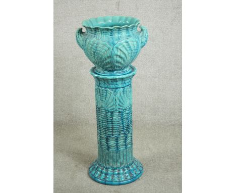 A late Victorian Burmantofts turquoise blue faience jardiniere and stand, moulded with shell designs, the stand impressed wit