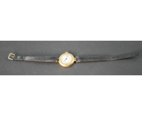 An 18ct carat gold vintage automatic ladies watch with white enamel dial and black leather strap. Case stamped 18 GS. (not wo