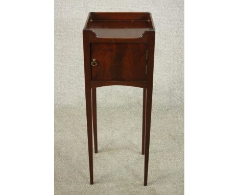 A 19th century mahogany night table, with a gallery top over a cupboard door, on slender tapering legs. H.81 W.30 D.30cm. 