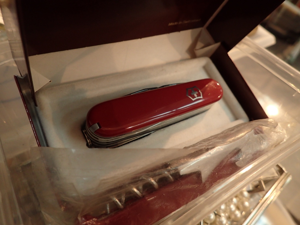 Boxed Victorinox Swiss army penknife and three wine bottle openers