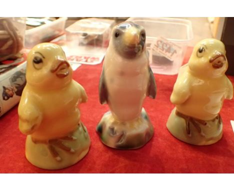 Two ceramic bottle yellow chicks and a penguins 