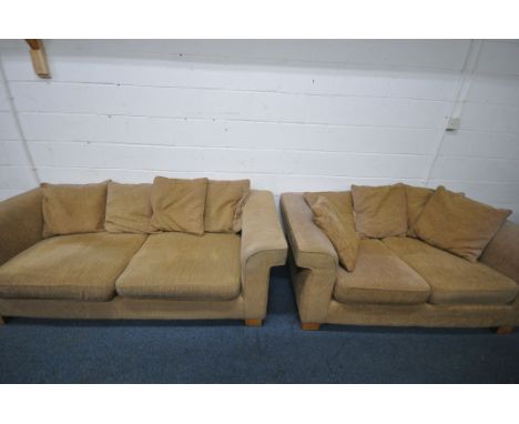 A BEIGE UPHOLSTERED TWO PIECE LOUNGE SUITE, comprising a three seater sofa, 214cm x depth 100cm x height 72cm, along with a t