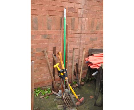A SELECTION OF GARDEN TOOLS including pick axe, axe, sledgehammers, forks, spades, hoes etc