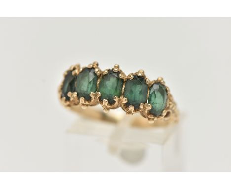 A 9CT GOLD FIVE STONE RING, set with five oval cut green tourmaline, each claw set, applied bead work detail, scrolling galle