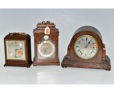 THREE WOODEN CASED MANTEL CLOCKS, comprising an Art Deco style Elliot clock retailed by Garrard &amp; Co, presentation plaque