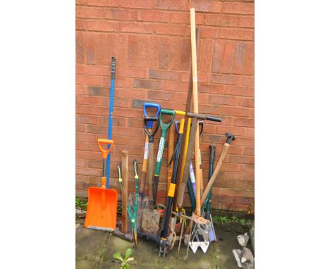 A SELECTION OF GARDEN TOOLS including a Fiskars weed puller,  pick axe, forks, shovels, etc