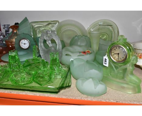 A GROUP OF DECORATIVE GLASS WARE, to include uranium glass dressing table items, including a figural clock (back rusty), seve