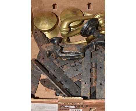 ONE BOX OF BRASS AND CAST IRON DOOR FURNITURE, to include two large brass door knobs, two brass door knockers, eight large ca