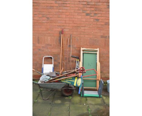 A WHEELBARROW, TWO DECK CHAIRS AND GARDEN TOOLS including a small step ladder, spades, forks, kneeler etc