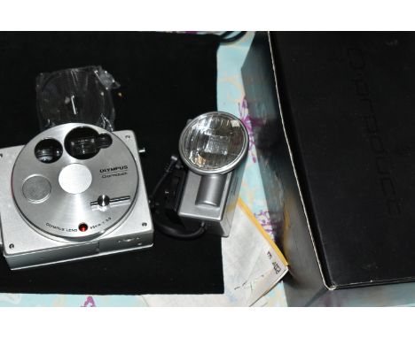 A BOXED OLYMPUS O-PRODUCT CAMERA SYSTEM,  comprising a 35mm compact camera with 35mm f3.5 lens, dedicated flashgun, camera st