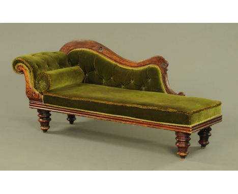 A Victorian chaise longue, with exposed carved frame, upholstered seat and bolster cushion.  Height to top of back 85 cm, len