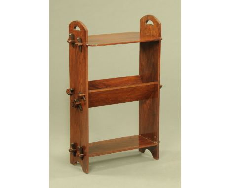 A mahogany Arts and Crafts book trough and combined shelf unit, with pegged brackets.  Height 94 cm, width 61 cm, depth 33 cm