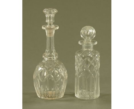 A club shaped cut glass decanter, and a cylindrical decanter. 