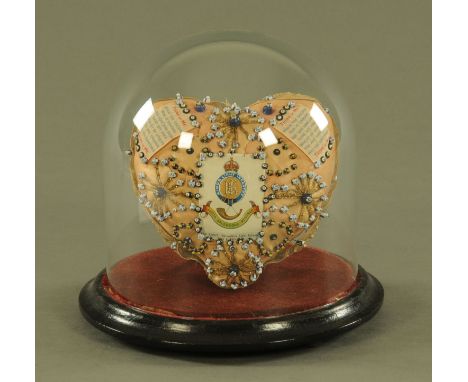 A World War I sweetheart Regimental cushion, housed under a glass dome and to the Kings Shropshire Light Infantry.  Cushion w