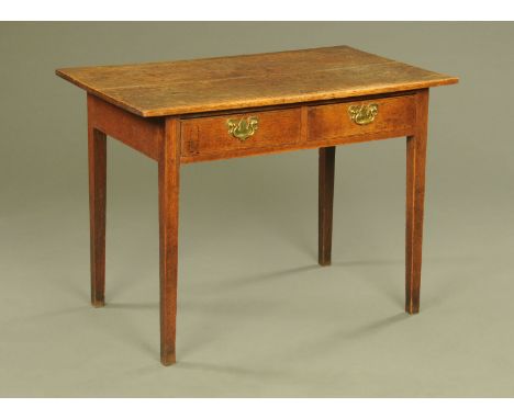 An 18th century oak side table, with two plank top and fitted with two frieze drawers with brass drop handles and shaped back