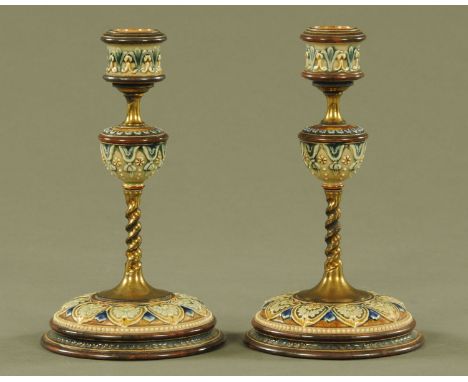 A pair of Doulton Lambeth ware candlesticks, with impressed marks to base.  Height 20 cm. CONDITION REPORT: Both candlesticks