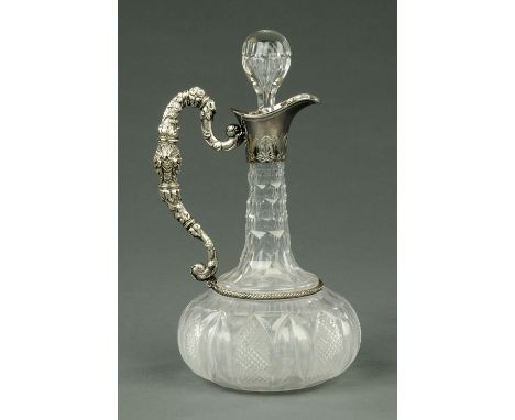 An Edwardian cut glass claret jug, club shaped with silver plated mount and scrolling mask and foliate handle (see illustrati