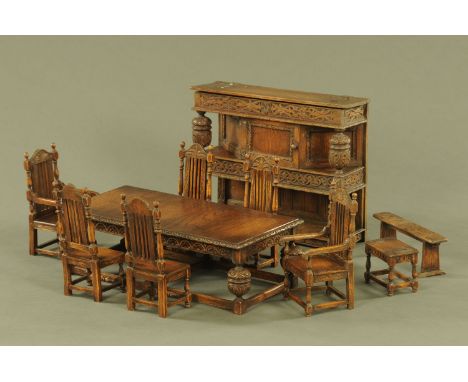 A miniature Elizabethan style carved oak dining room suite, comprising refectory table, court cupboard, 6 chairs, bench and s