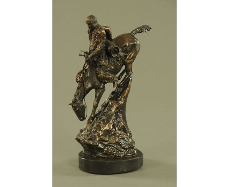 After Frederick Remington, a bronze figure of a Native American on horseback.  Height 40 cm including base (see illustration)