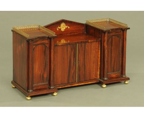A Regency rosewood tabletop cabinet, of architectural form with inverted breakfront above a series of four doors enclosing sh