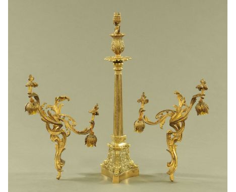 A Victorian brass table lamp, with moulded triangular base, height to top of light fitting 60 cm, and a pair of Rococo scroll