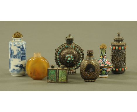 A collection of Chinese and other eastern snuff bottles, ceramic, enamel, silver coloured metal, jewelled and inlaid mother o