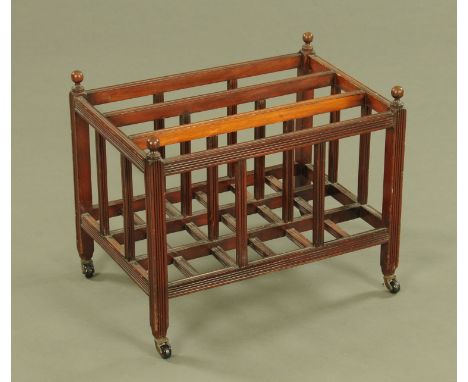 A 19th century mahogany Canterbury, three divisions and raised on brass mounted ceramic castors.  Width 49 cm.