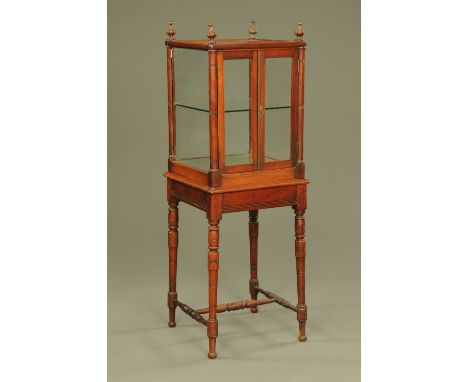 A Victorian mahogany shop display cabinet, with four turned finials, glazed and mirrored upper section and raised on turned l