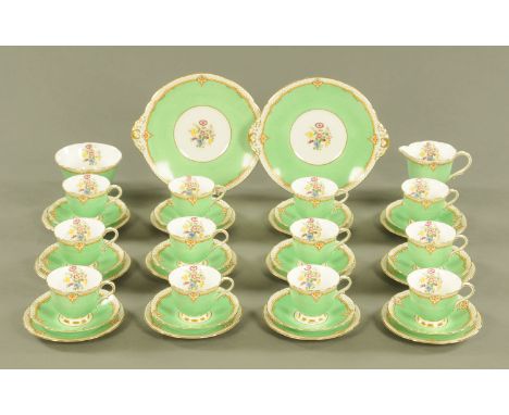 An Adderley Ware tea service, 12 cups, 12 saucers, 12 plates, 2 sandwich plates and a basin, with green band and handpainted 