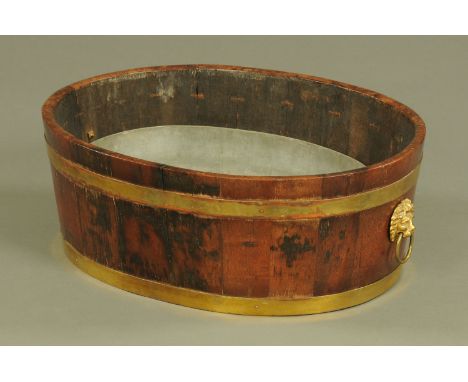 A 19th century oak brass bound planter, with galvanised liner and lion mask handle to either end.  Width 62 cm. CONDITION REP