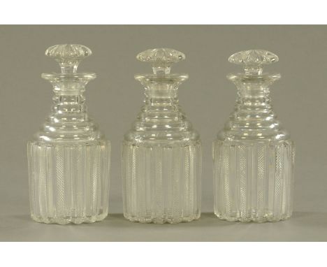 A set of 3 George III glass decanters, each with cut glass stopper.  Height 24.5 cm.  CONDITION REPORT: One decanter is in ge