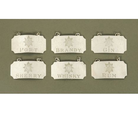 Six silver decanter labels, maker William Comyns, London 1948.