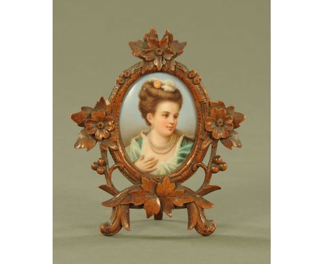 A German porcelain portrait panel of a lady, in Black Forest easel frame.  Height 16 cm, width 13.5 cm. 