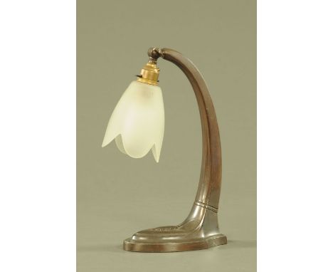An Art Nouveau metal lamp, with frosted glass shade.  Height 31 cm. 