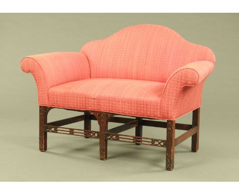 A George III style mahogany small settee, with arched back, rollover arms, blind fret carved legs and spandrels.  Height to t