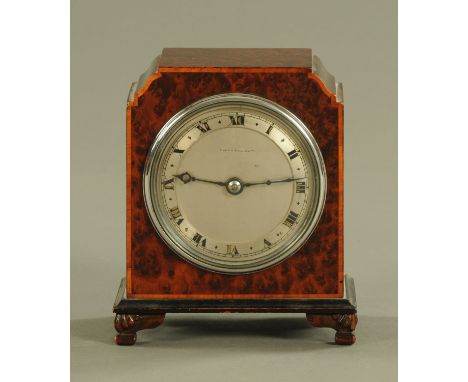 A Mappin & Webb mantle clock, with burr yew veneered case, single train movement raised on carved bracket feet.  Height 15 cm