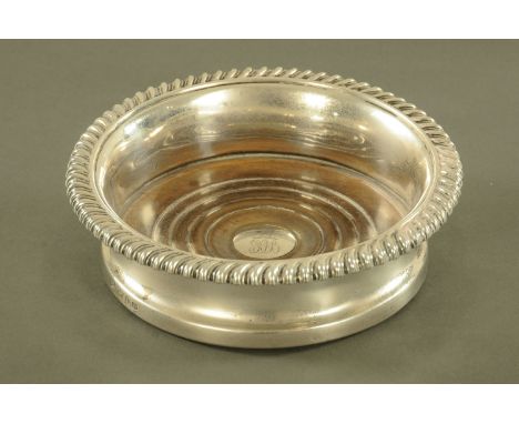 A George IV silver decanter coaster, Sheffield 1829 maker John Settle and Henry Wilkinson.  Diameter 16 cm.