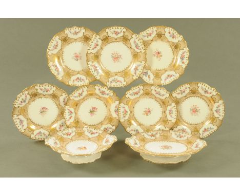 A 19th century handpainted part dessert service, comprising 7 plates and 2 comports, with buff ground and floral sprays.  Pla