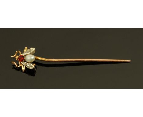 A gold coloured metal stick pin with insect terminal set with diamonds, pearl and a ruby coloured stone.