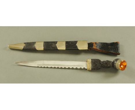 A late Victorian Scottish dirk, with citrine pommel, plated mounts and leather scabbard, blade length 28.5 cm, overall length