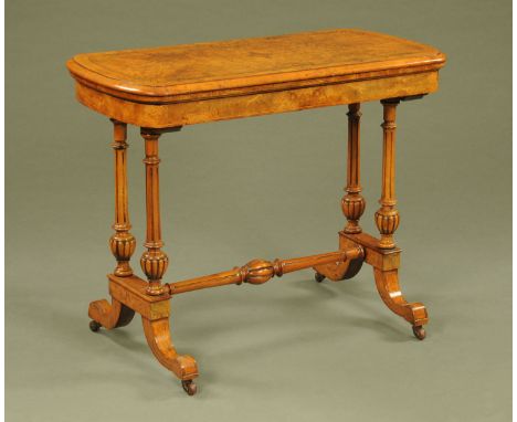 A Victorian burr walnut marquetry turn over top card table, with moulded edge and supported by four turned fluted columns wit