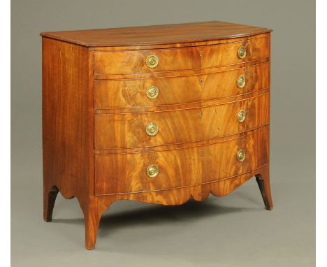 A George III mahogany bow fronted chest of drawers, with moulded edge above four long graduated drawers with circular brass d