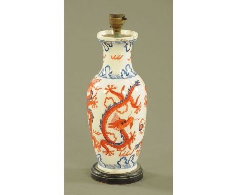 A Chinese vase, converted to a table lamp, decorated with dragons.  Height excluding light fitting 26 cm. 