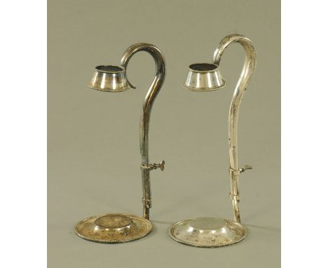 A pair of silver plated adjustable wine bottle holders.