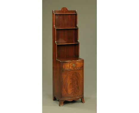 A mahogany narrow shelf unit and combined bowfronted cupboard, raised on splayed bracket feet.  Height 151 cm, width 40 cm, d