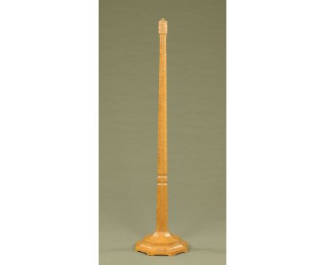 A Mouseman Thompson of Kilburn oak lamp standard, with faceted column and typical mouse trademark.  Height excluding light fi